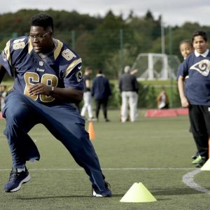 Los Angeles Rams guard Jamon Brown takes part in a drill during an NFL community event for schoolchildren at Surrey Sports Park in Guildford, England, Tuesday, Oct. 18, 2016. The Los Angeles Rams are due to play the New York Jets at Twickenham stadium in London on Sunday in a regular season NFL game. (AP Photo/Matt Dunham)
